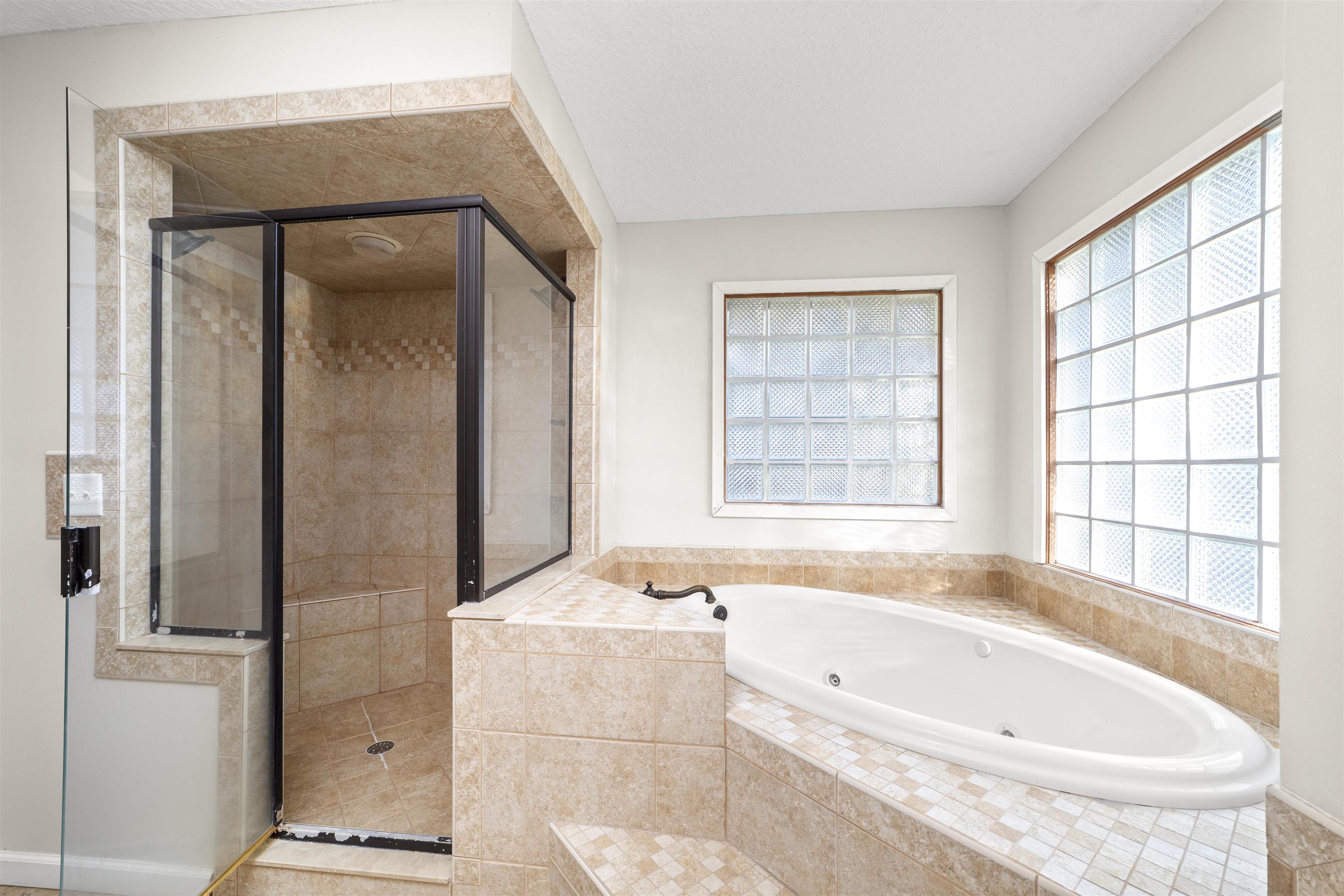 545 Ray Edwards Road St. Augustine, FL 32086 - Photo 43 of 78 Full bathroom with a shower stall and a tub with jets