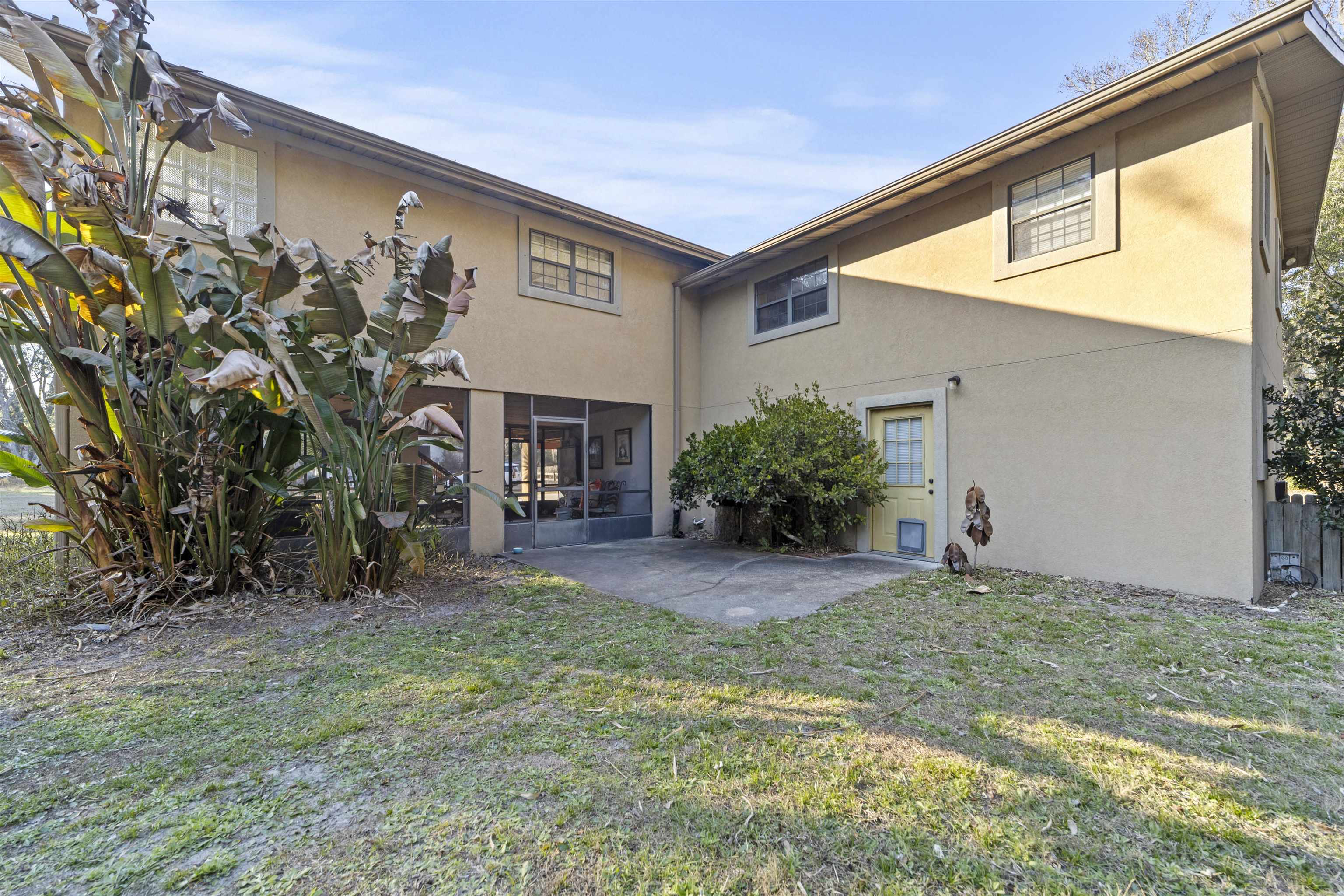 545 Ray Edwards Road St. Augustine, FL 32086 - Photo 5 of 78 Back of property featuring stucco siding and a lawn