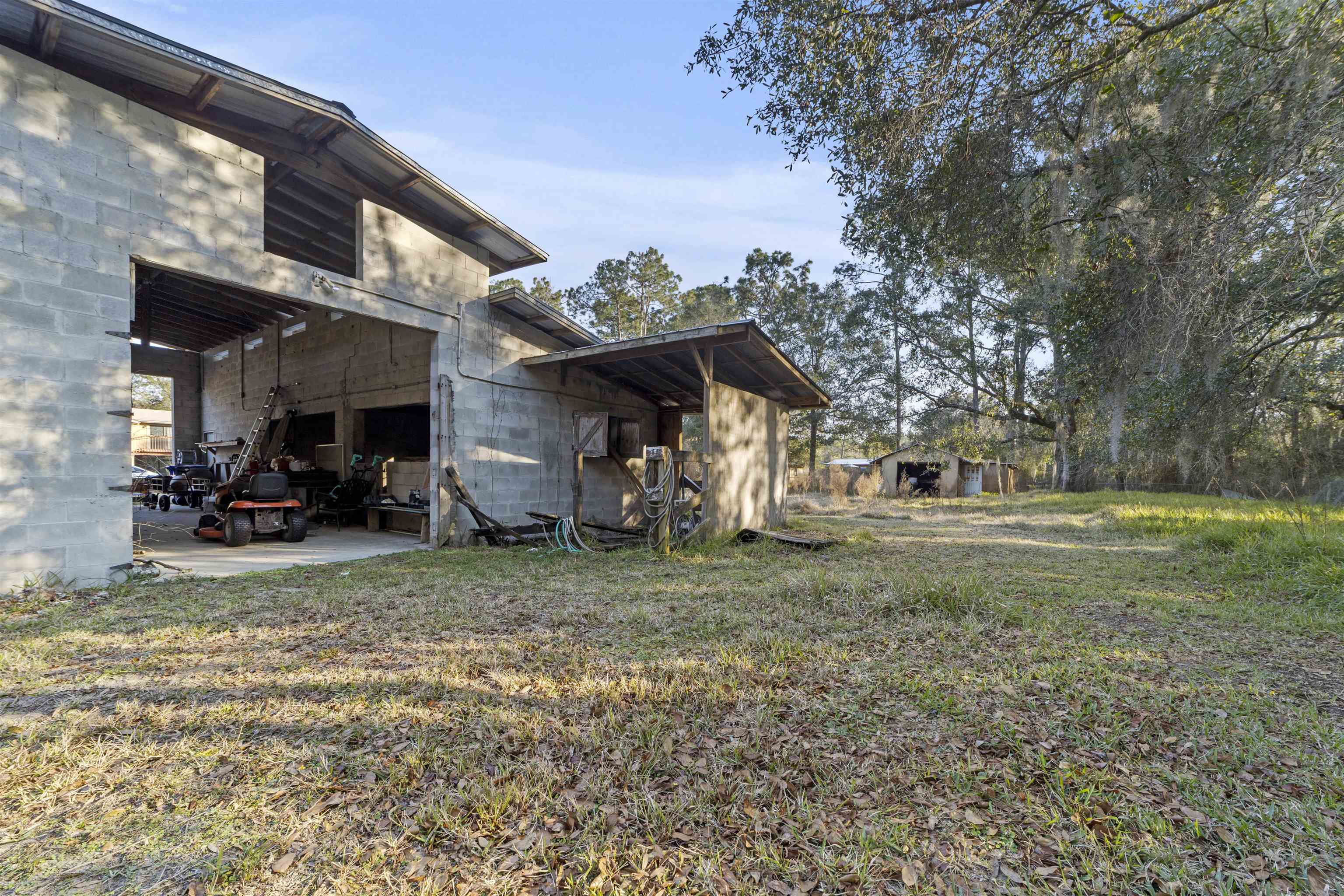545 Ray Edwards Road St. Augustine, FL 32086 - Photo 58 of 78 View of property exterior with a patio area, a lawn, and an outdoor structure