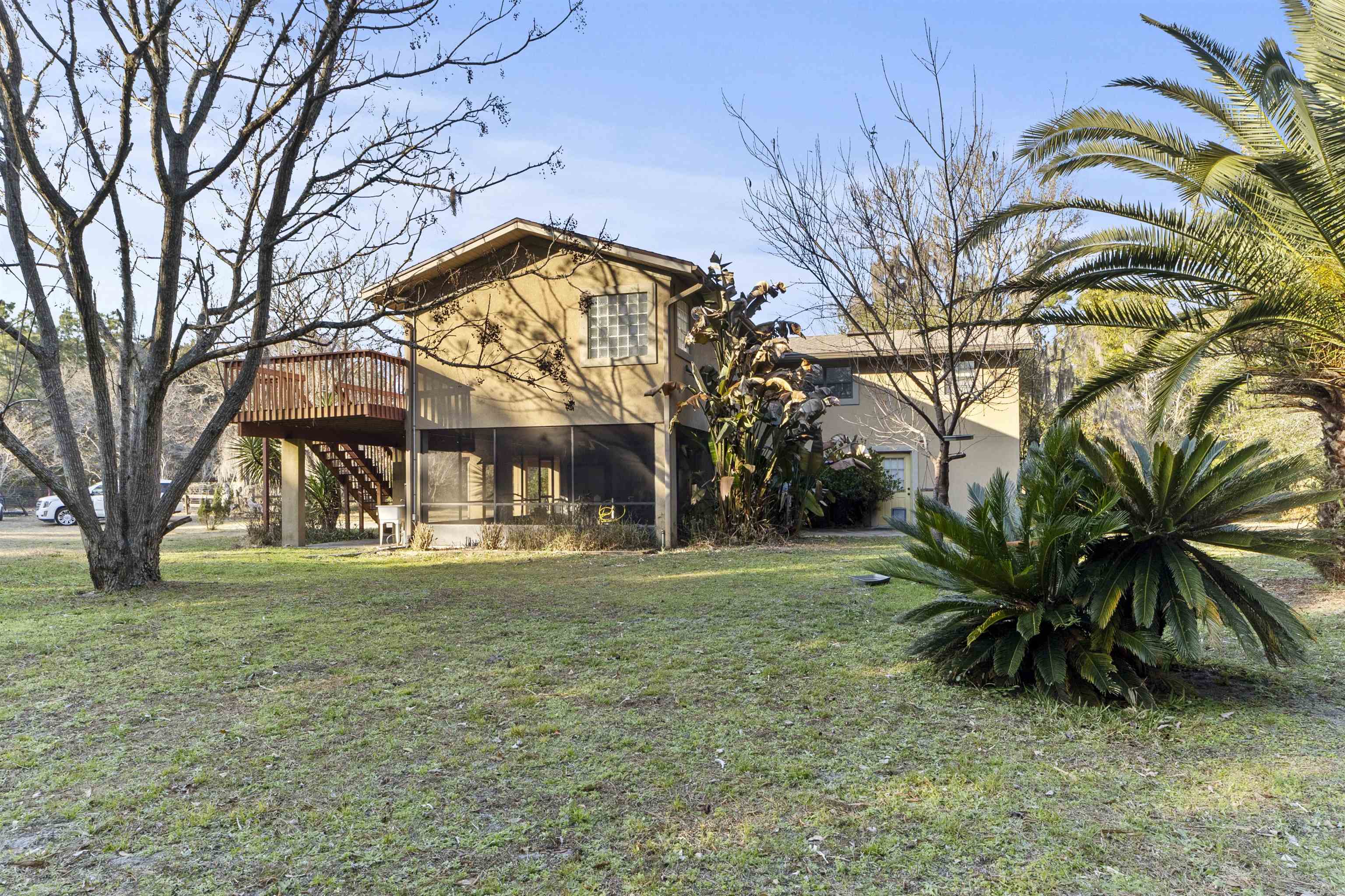 545 Ray Edwards Road St. Augustine, FL 32086 - Photo 6 of 78 View of front facade featuring a front lawn, stucco siding, and a wooden deck