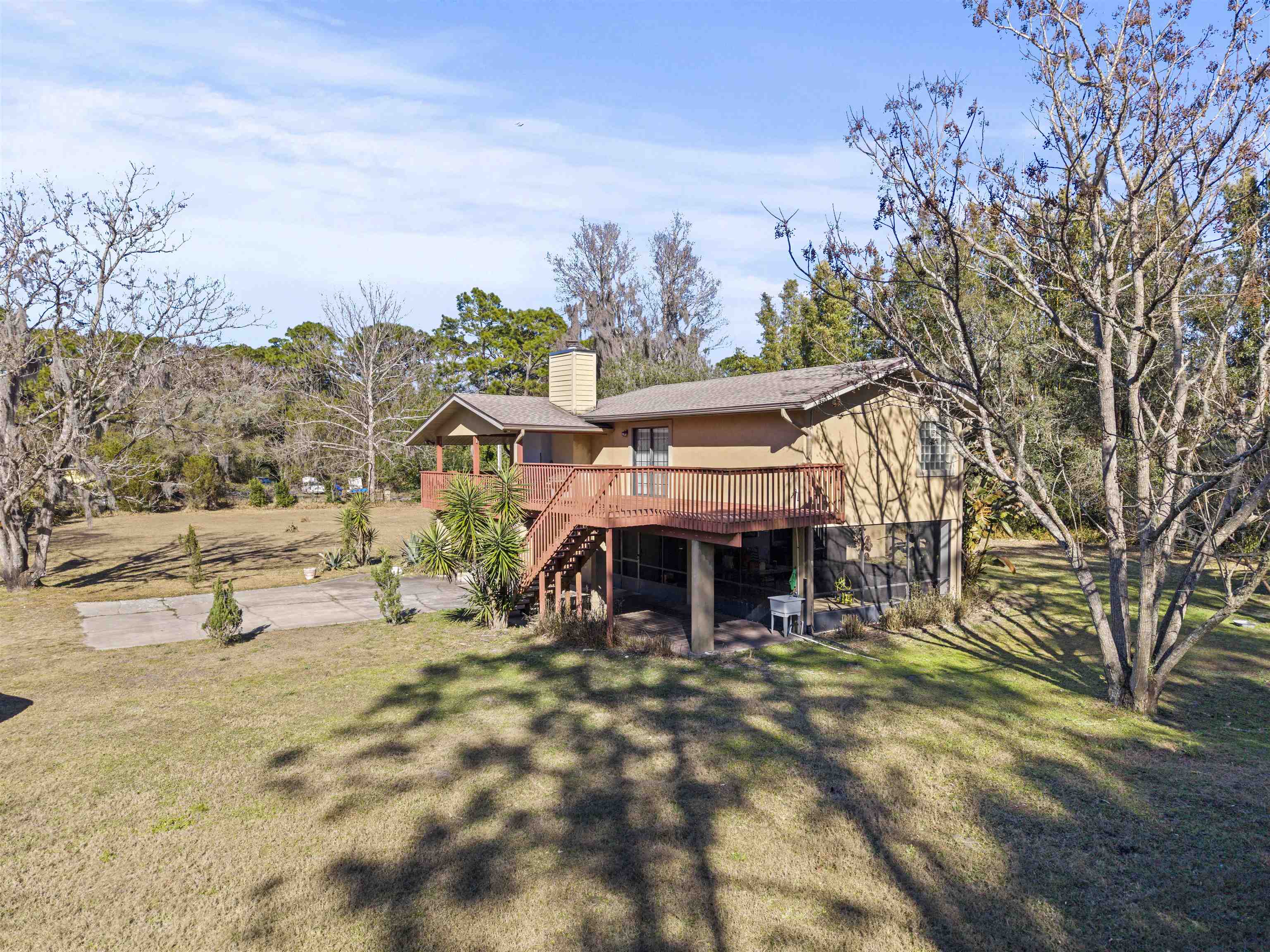 545 Ray Edwards Road St. Augustine, FL 32086 - Photo 8 of 78 Back of property featuring a patio area, stairway, a chimney, a lawn, and a deck