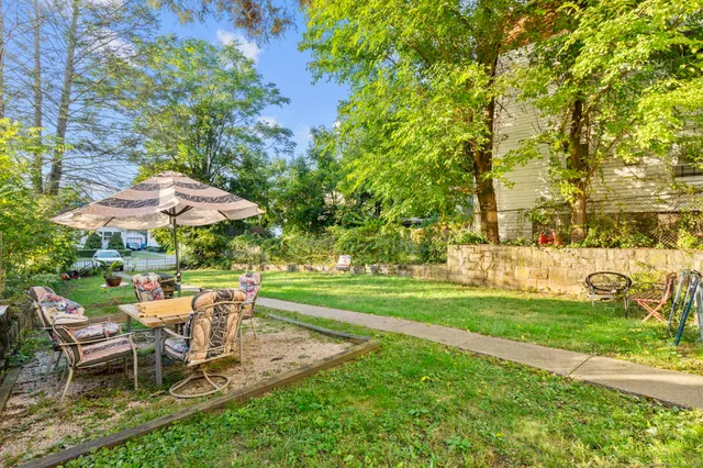 a view of a table and chairs under an umbrella