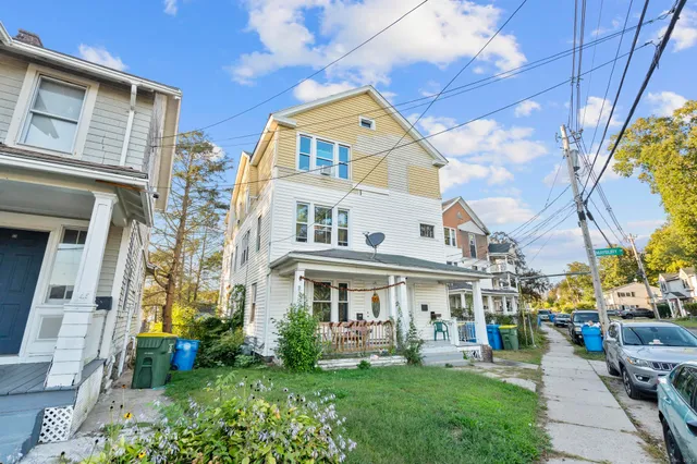 a front view of a building with a garden
