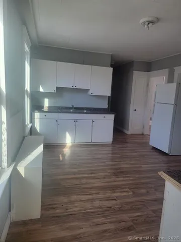 a room with a wooden floor and cabinets