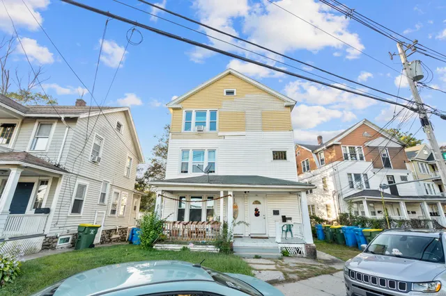 a front view of a residential apartment building with a yard