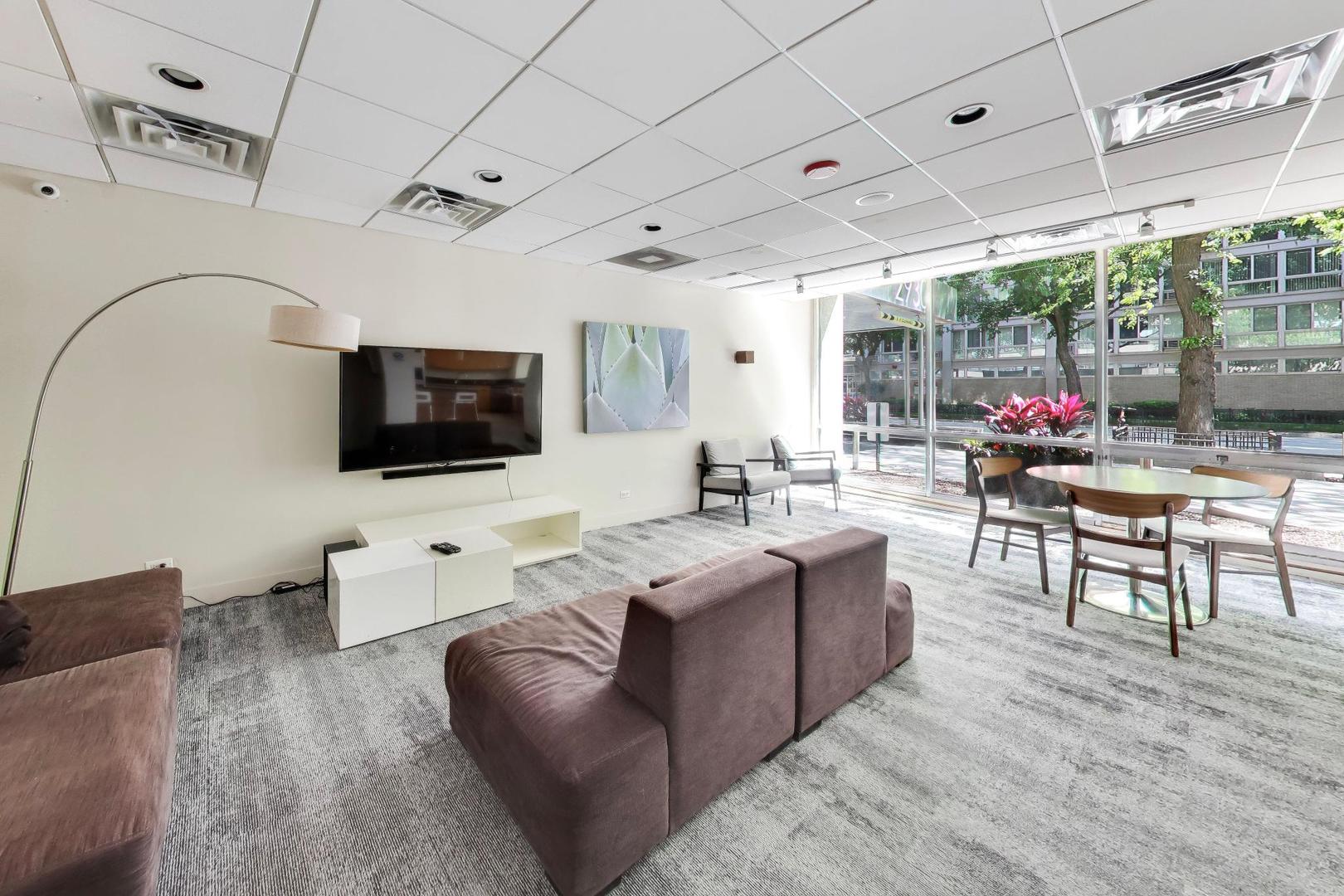 2930 North Sheridan Road, Unit 702 Chicago, IL 60657 - Photo 15 of 25 a living room with furniture and a flat screen tv