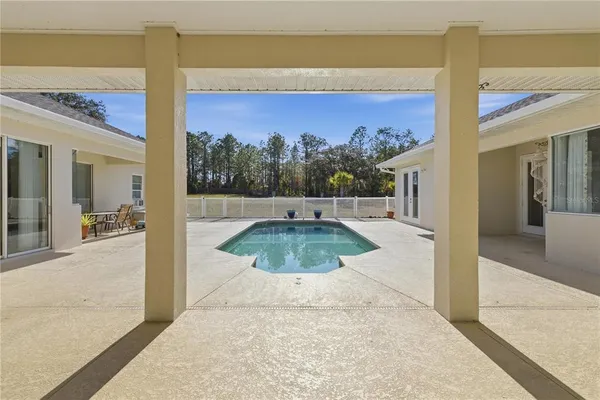 a view of a house with a yard and sitting area