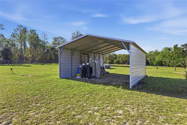 a aerial view of a house with a yard and a large tree