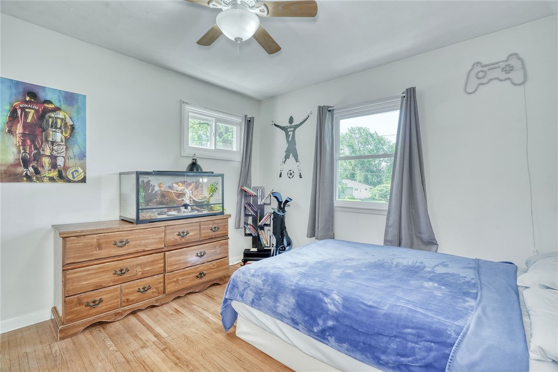 1038 Whalen Road Penfield, NY 14526 - Photo 20 of 46 Bedroom number one with ceiling, fan and hardwood