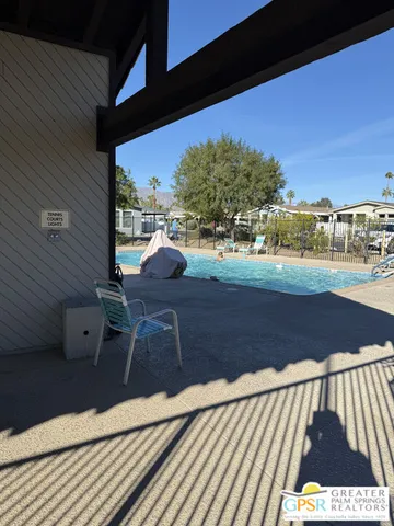 a living room with furniture and a book shelf