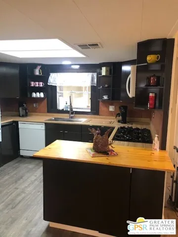 a kitchen with a sink and a stove top oven
