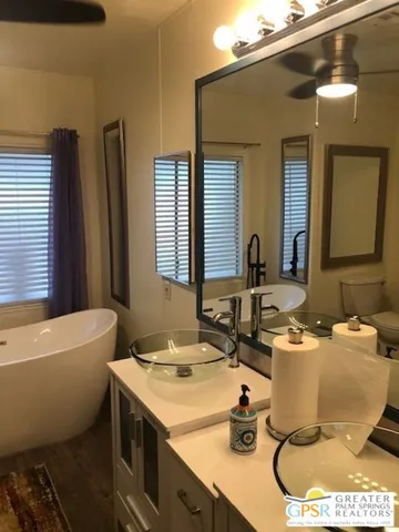 a bathroom with a sink mirror toilet and bathtub