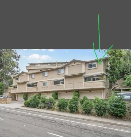 a front view of a building with a garden and plants