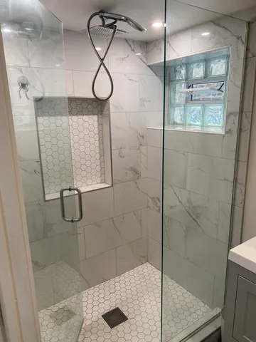 a bathroom with a glass shower door