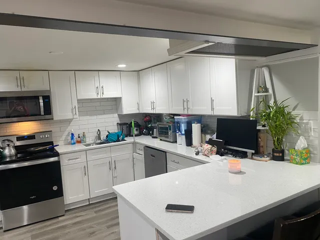 a kitchen with a sink a stove and cabinets