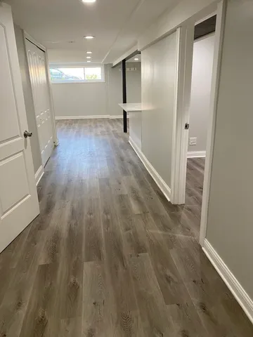 a view of a hallway with wooden floor