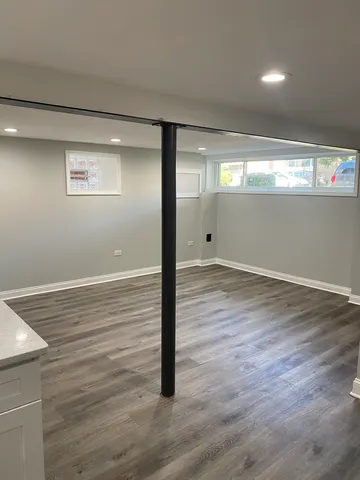 a view of a room with wooden floor