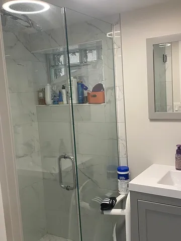 a bathroom with a shower and a sink
