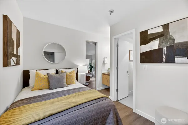 a bedroom with a bed and a flat tv screen on dresser