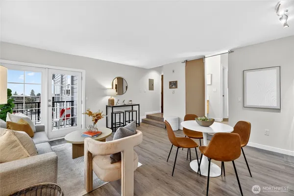 a dining room with furniture and wooden floor