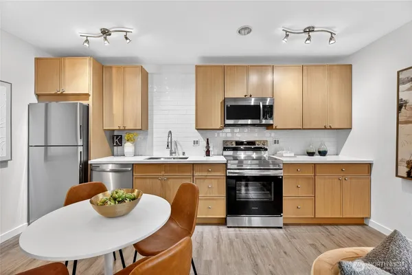 a kitchen with a stove a sink and a refrigerator