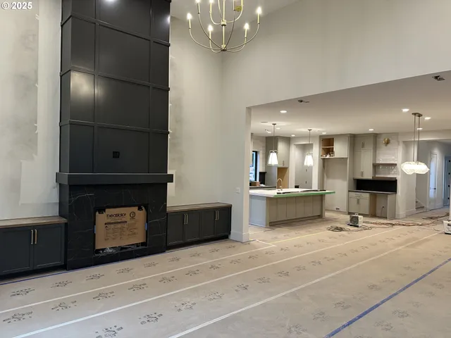a living room with stainless steel appliances kitchen island granite countertop furniture and fireplace