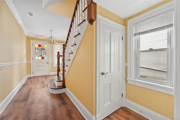 a view of an entryway with wooden floor