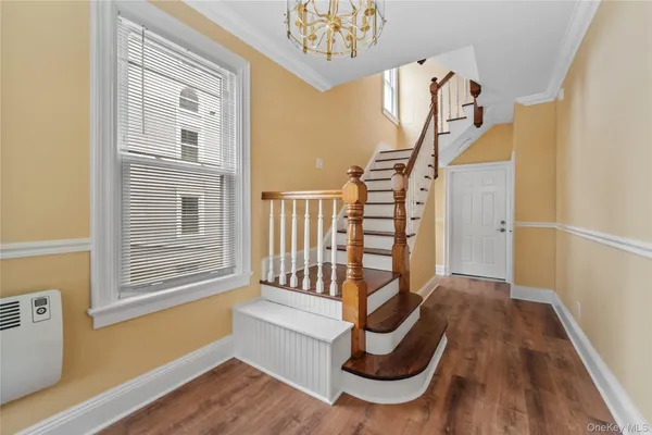 a view of entryway with wooden floor and stairs