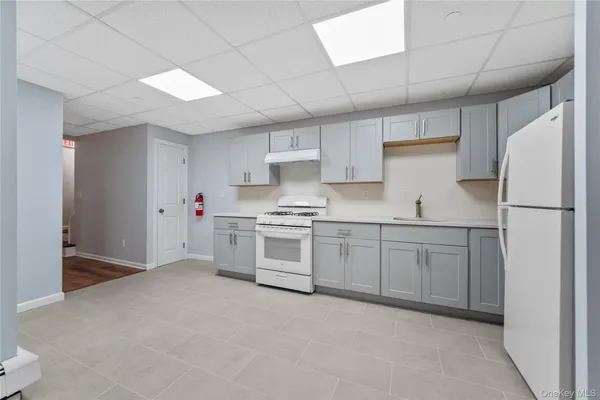 a kitchen with cabinets stainless steel appliances and counter space