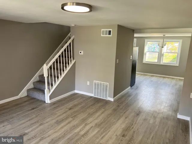a view of an entryway with wooden floor