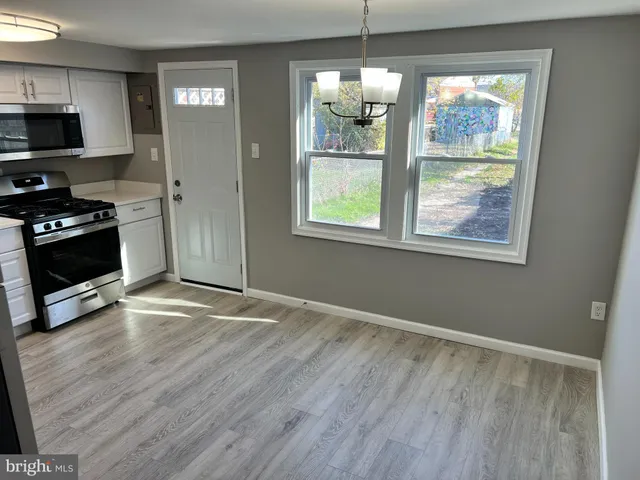 a kitchen with stainless steel appliances a refrigerator a stove a microwave and cabinets