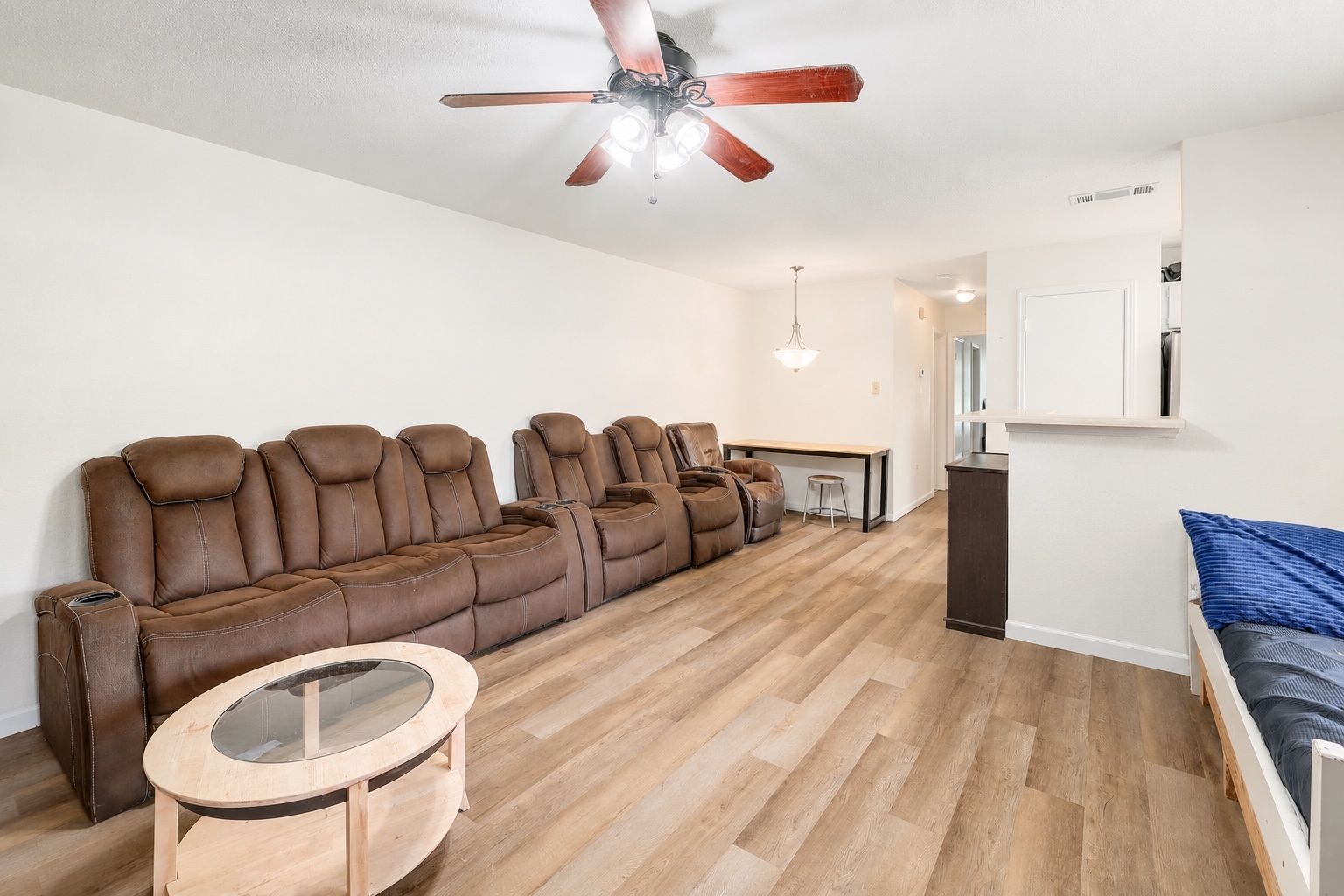 9906 Parliament House Road Austin, TX 78729 - Photo 15 of 33 Smooth wood-style flooring anchors this open living space with neutral walls.