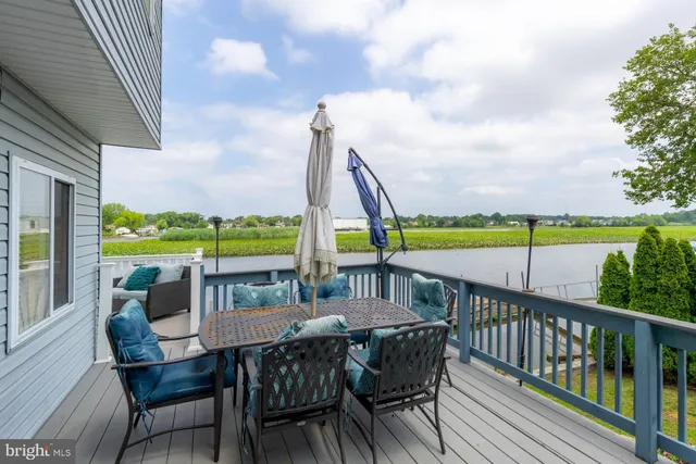 a view of a city from a dining room with furniture and wooden floor