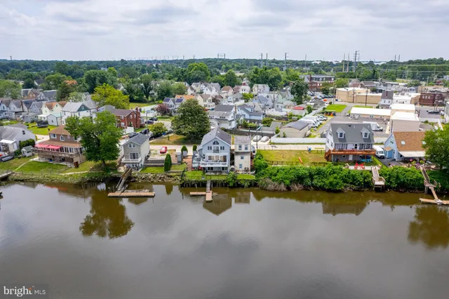 an aerial view of a houses with a lake view