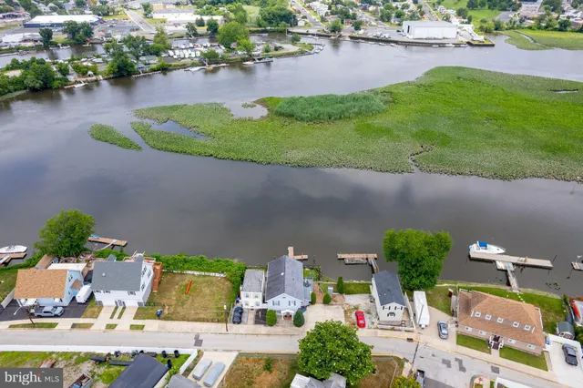 a aerial view of a house with a garden and lake view