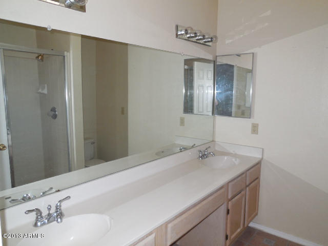 170 East Guadalupe Road, Unit 148 Gilbert, AZ 85234 - Photo 13 of 29 a bathroom with a sink and a mirror