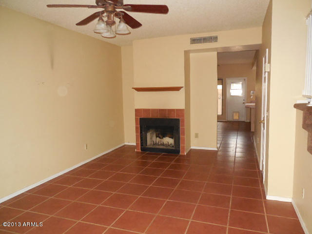 170 East Guadalupe Road, Unit 148 Gilbert, AZ 85234 - Photo 2 of 29 a view of an empty room with a chandelier fan