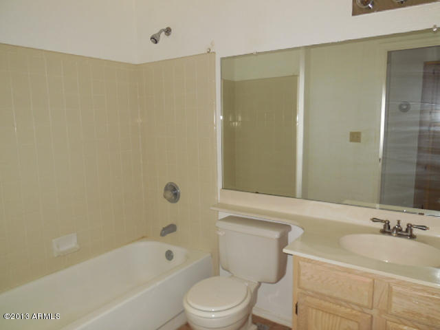 170 East Guadalupe Road, Unit 148 Gilbert, AZ 85234 - Photo 21 of 29 a bathroom with a sink a toilet and shower