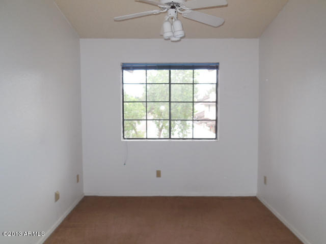 170 East Guadalupe Road, Unit 148 Gilbert, AZ 85234 - Photo 22 of 29 an empty room with a window