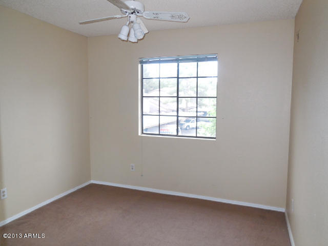 170 East Guadalupe Road, Unit 148 Gilbert, AZ 85234 - Photo 23 of 29 an empty room with a window