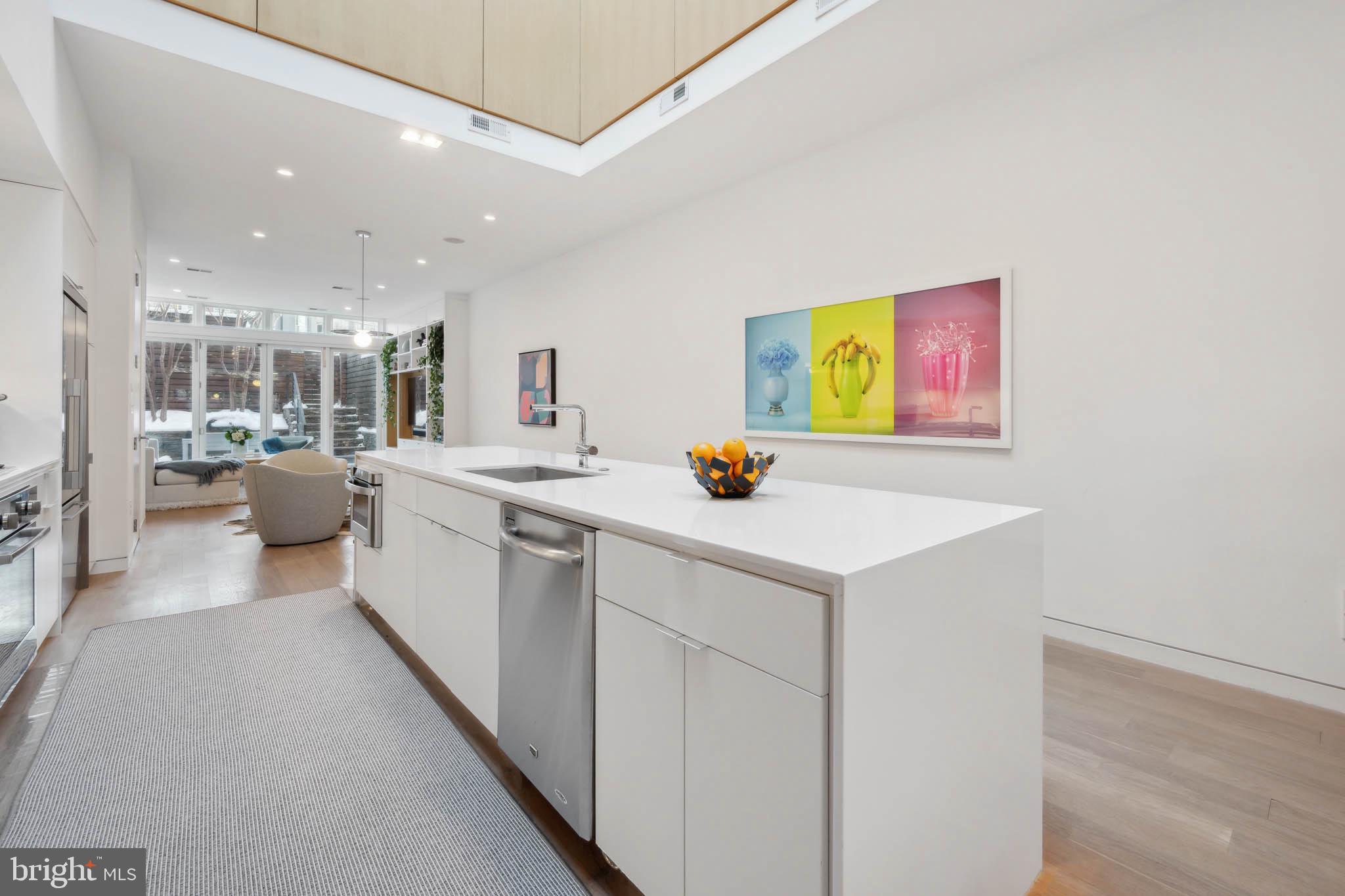 1325 Constitution Avenue Northeast Washington, DC 20002 - Photo 12 of 36 a kitchen with a sink cabinets and wooden floor