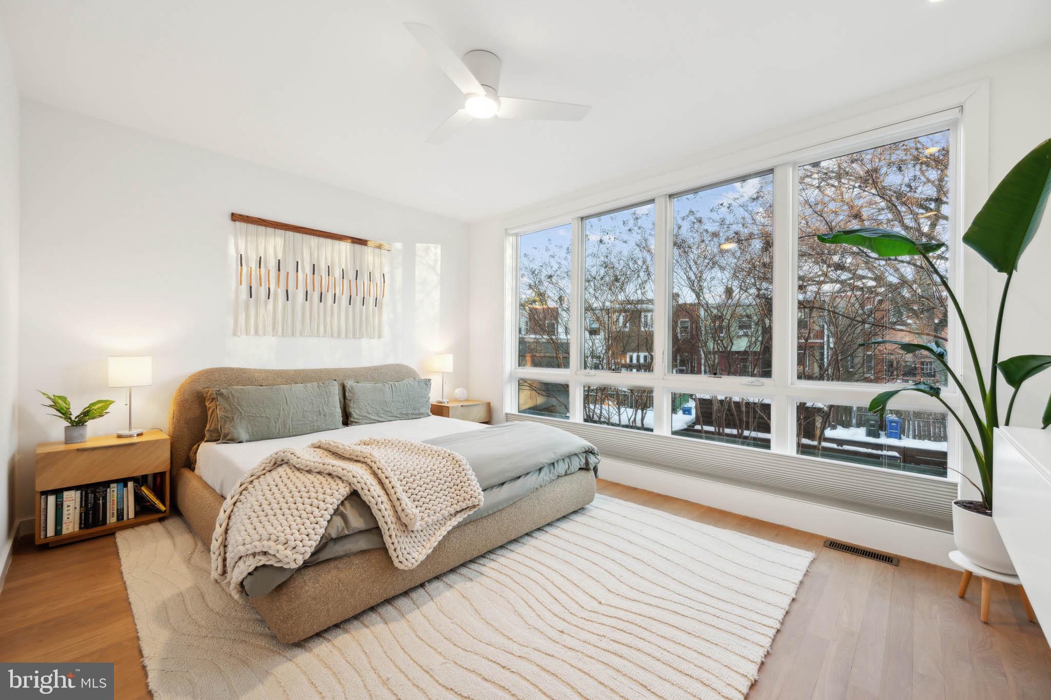1325 Constitution Avenue Northeast Washington, DC 20002 - Photo 17 of 36 a spacious bedroom with a large bed and a large window with outer view