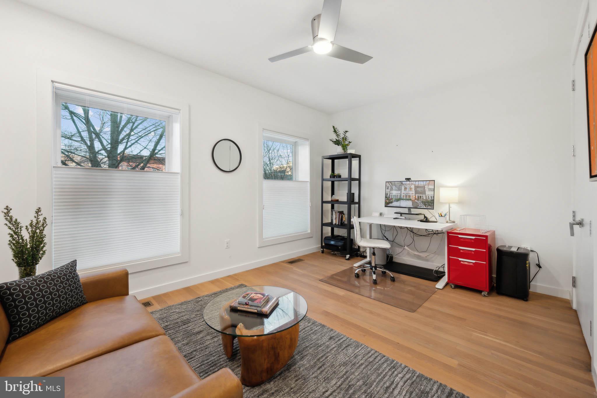 1325 Constitution Avenue Northeast Washington, DC 20002 - Photo 21 of 36 a living room with furniture and wooden floor