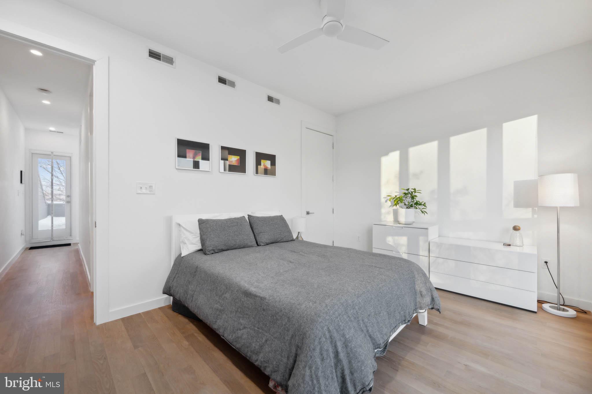 1325 Constitution Avenue Northeast Washington, DC 20002 - Photo 27 of 36 a bedroom with a large bed and wooden floor