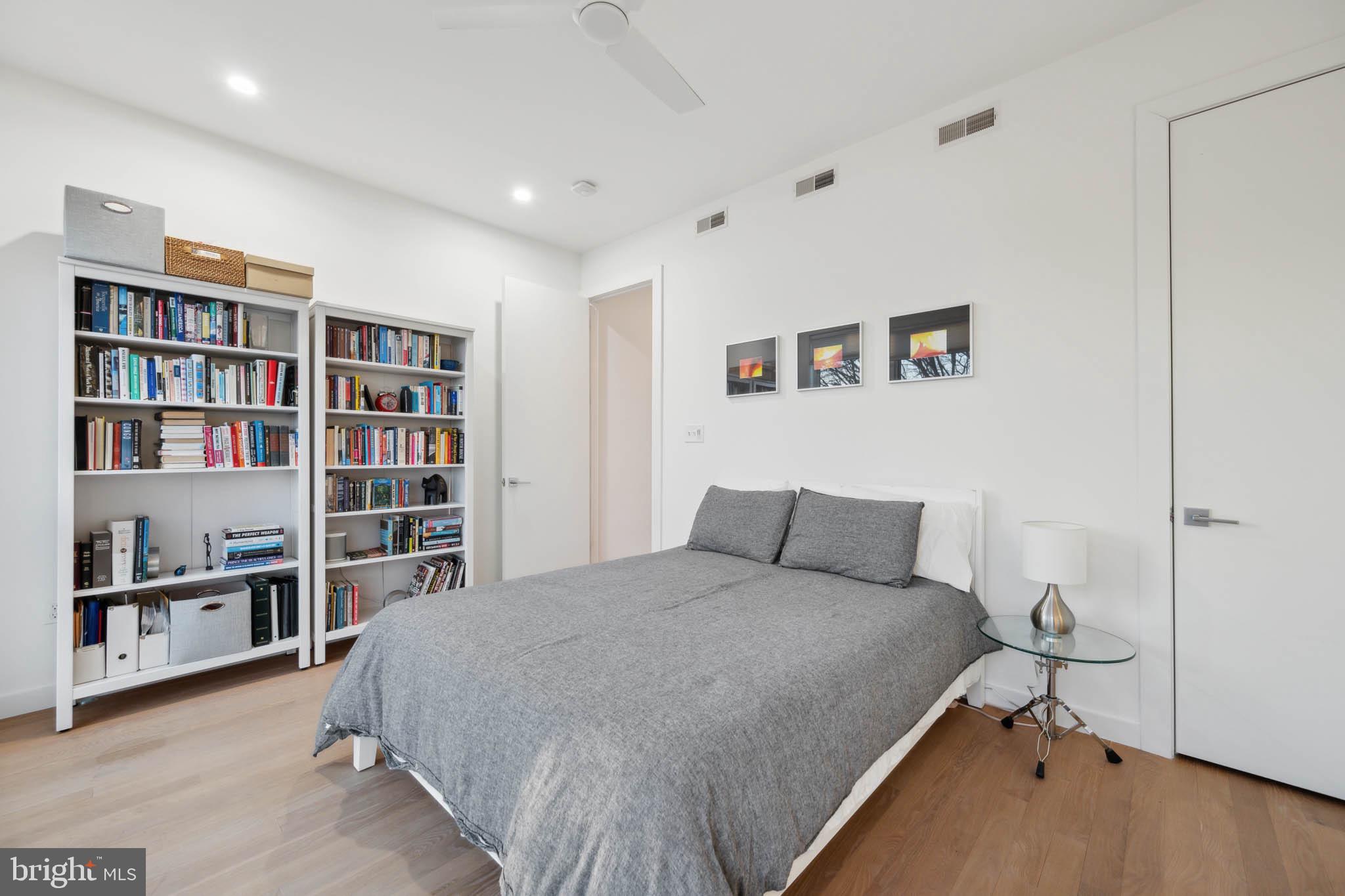1325 Constitution Avenue Northeast Washington, DC 20002 - Photo 28 of 36 a bedroom with a bed and a book shelf