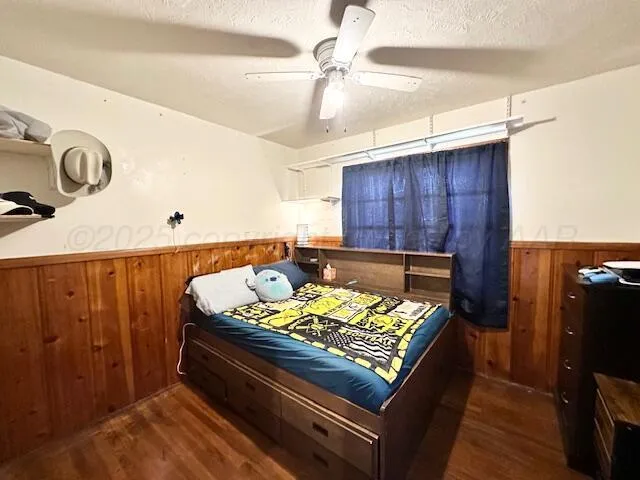a bed sitting in a room next to a cabinet