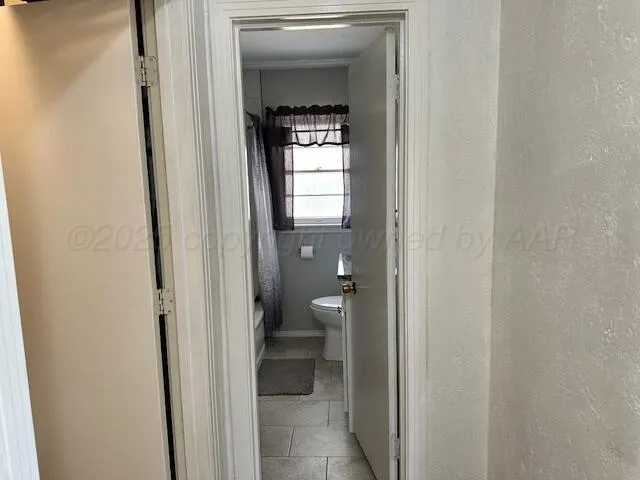 a view of a bathroom from a hallway