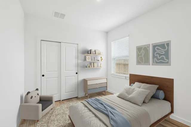 a bedroom with a bed and a couch