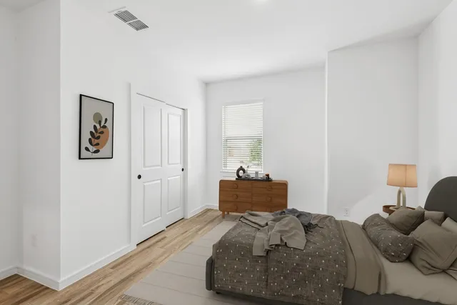 a bedroom with a bed and a window