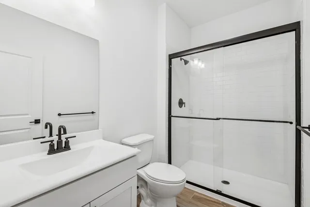 a bathroom with a sink toilet and shower